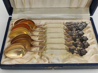 Set of seven silver rose-pattern coffee spoons from various years
